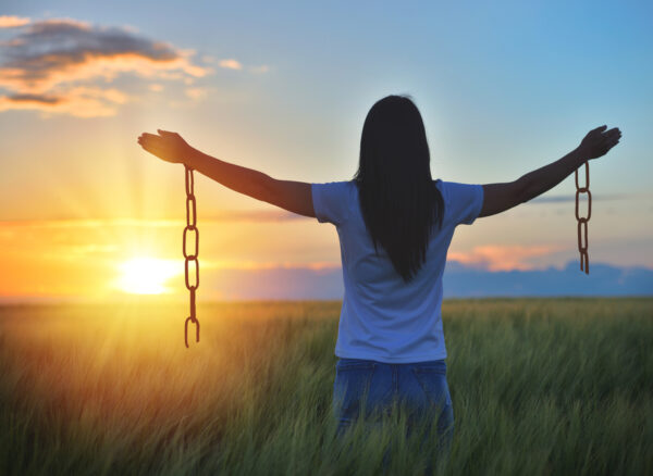 Woman feeling free in a beautiful natural setting, in what field